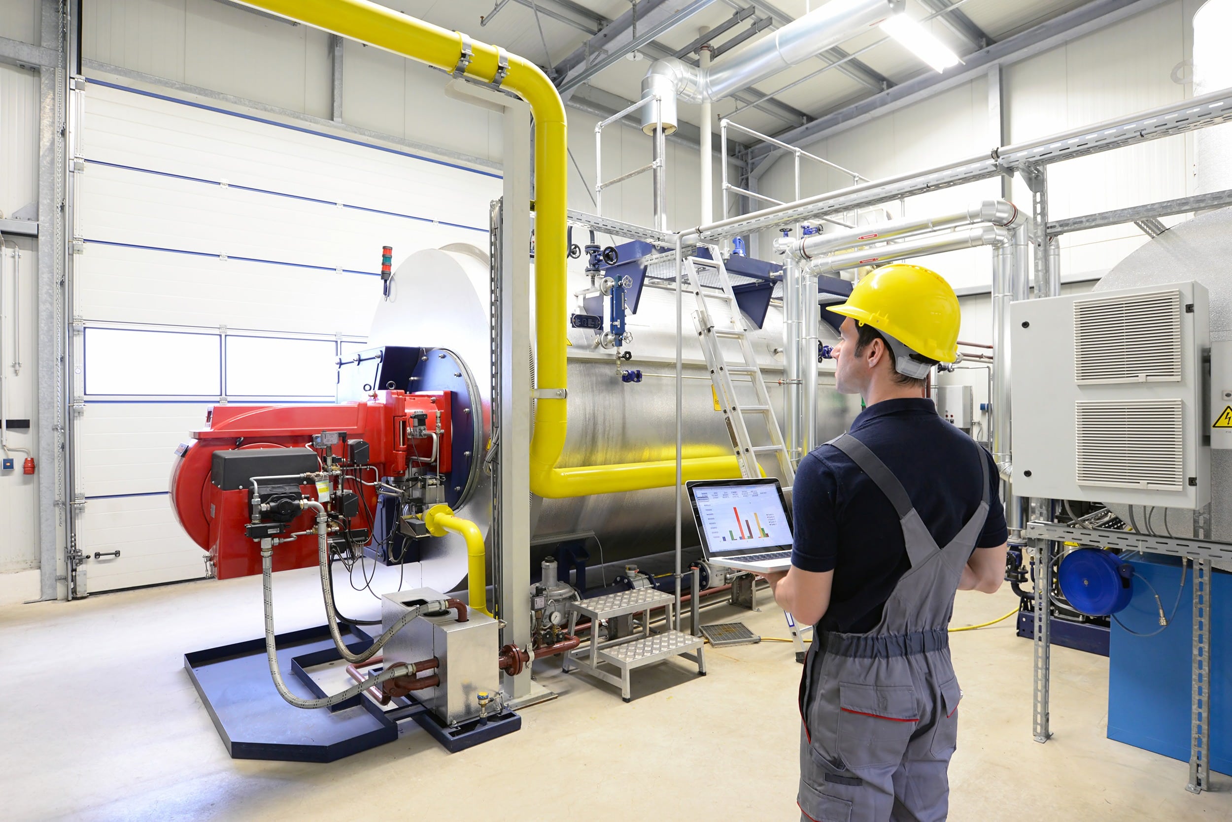 Technician near Gas Boiler wearing Hard hat